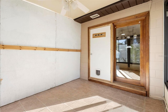 tiled spare room featuring ceiling fan