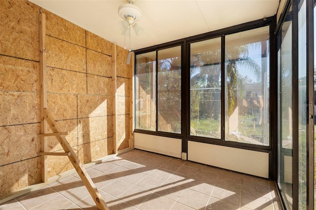 unfurnished sunroom with ceiling fan