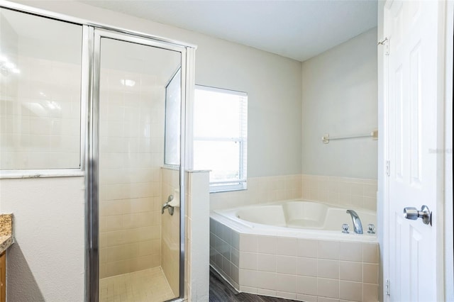 bathroom with vanity and independent shower and bath