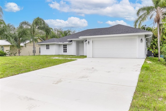 ranch-style house featuring central AC, a garage, and a front lawn