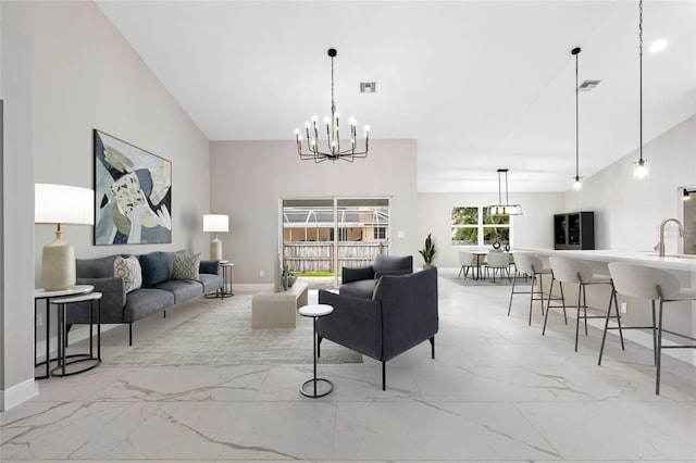 living room featuring vaulted ceiling, sink, and an inviting chandelier