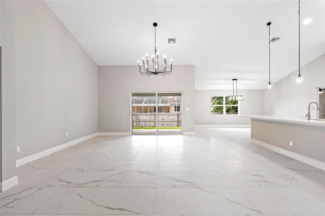 interior space with sink, a chandelier, and vaulted ceiling