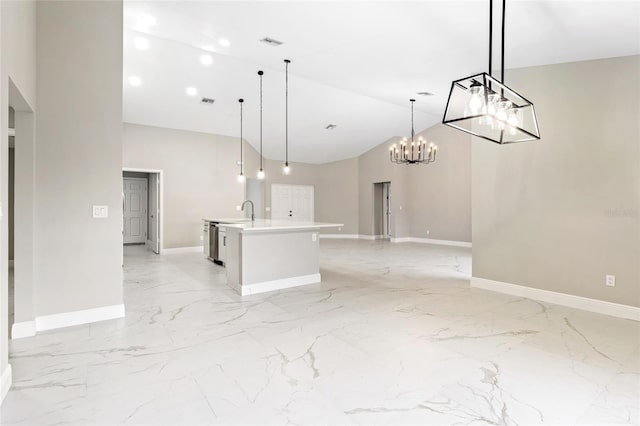 kitchen featuring a center island with sink, sink, hanging light fixtures, and high vaulted ceiling