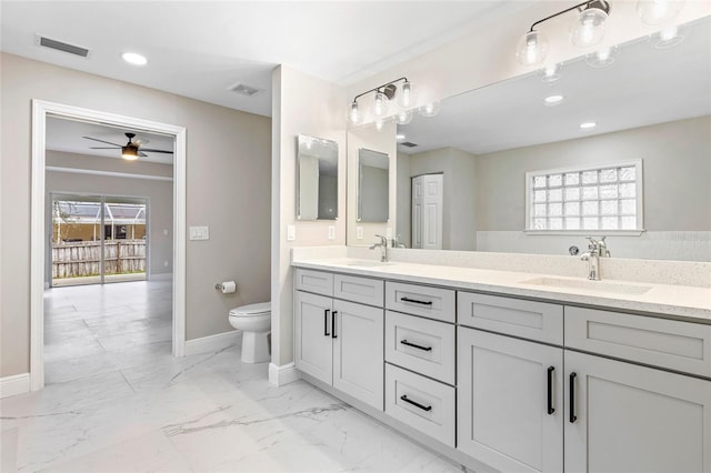 bathroom with vanity, toilet, a wealth of natural light, and ceiling fan