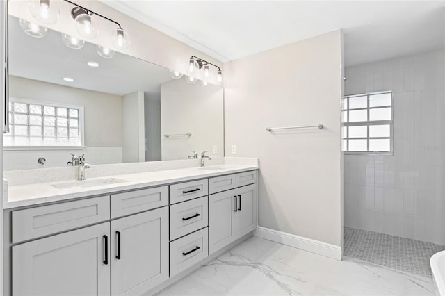 bathroom with vanity and tiled shower