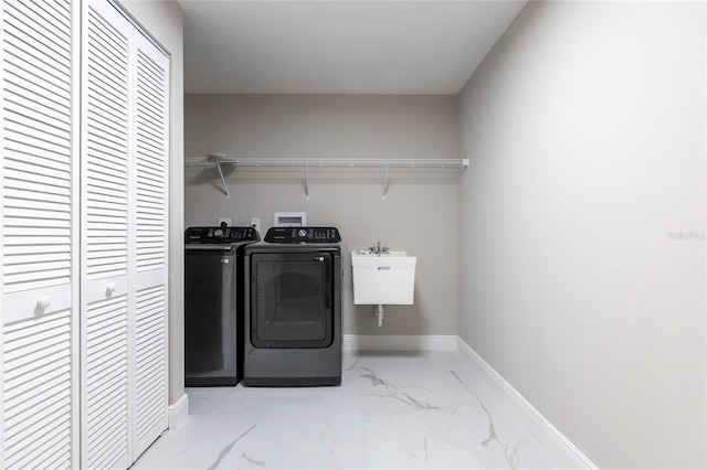 washroom featuring washer and dryer and sink