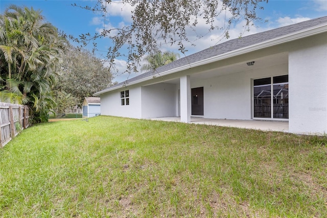 back of house featuring a yard and a patio