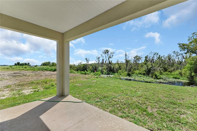 view of yard featuring a patio and a water view