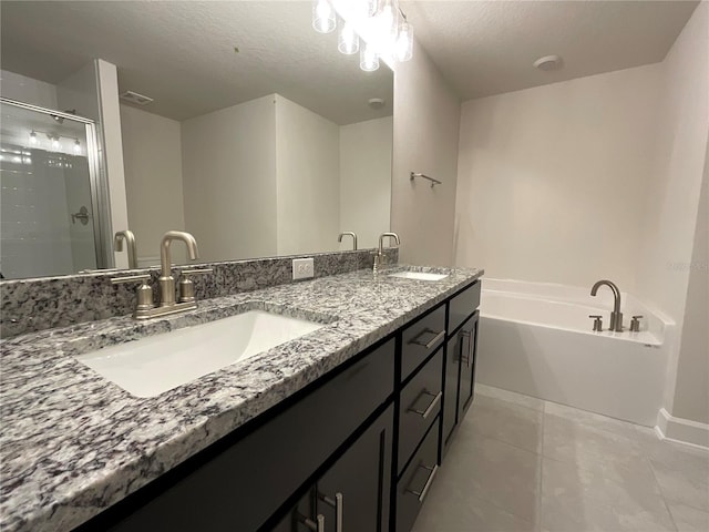 bathroom with tile patterned floors, shower with separate bathtub, a textured ceiling, and vanity