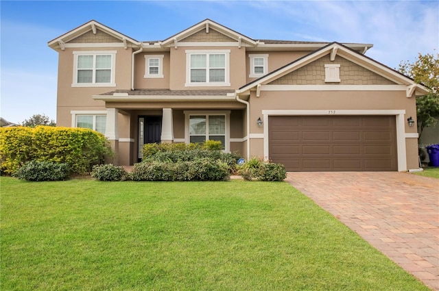 view of front of property featuring a garage and a front lawn