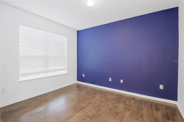 empty room with hardwood / wood-style floors