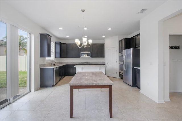 kitchen with stainless steel appliances, sink, a notable chandelier, hanging light fixtures, and light tile patterned flooring