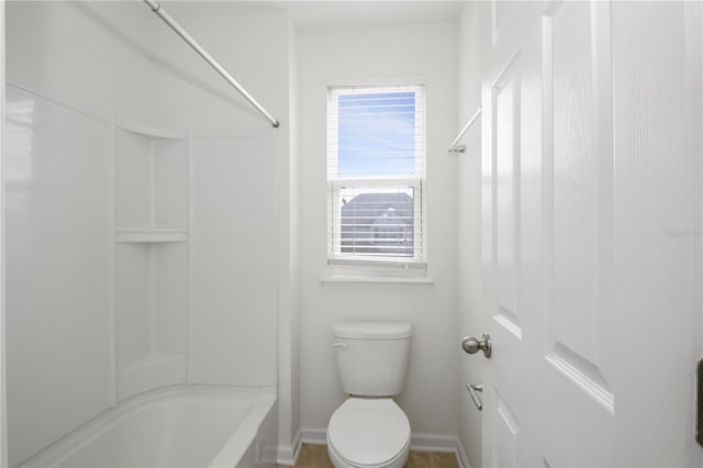 bathroom with bathtub / shower combination, toilet, and a healthy amount of sunlight