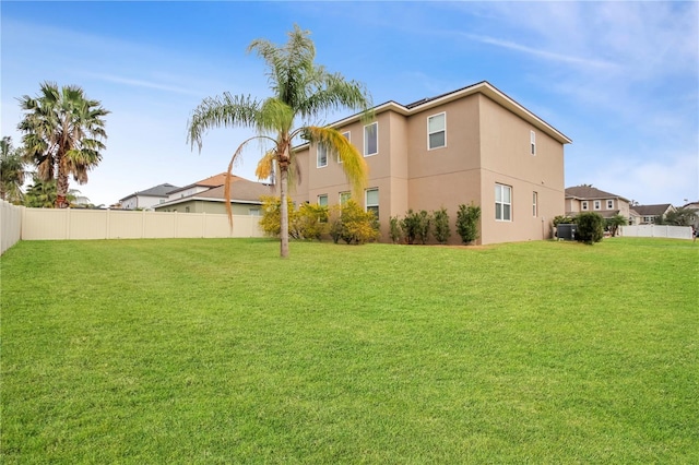 back of house with a lawn