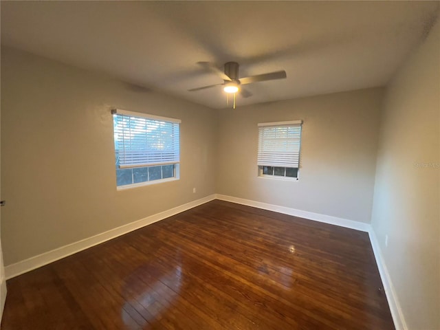 spare room featuring ceiling fan and dark wood-type flooring