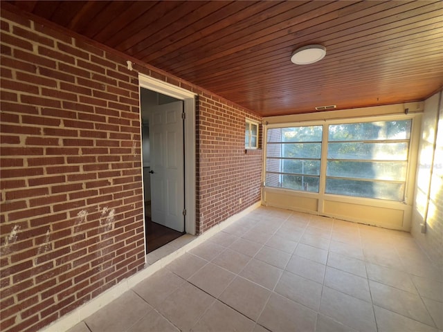 unfurnished sunroom with wooden ceiling