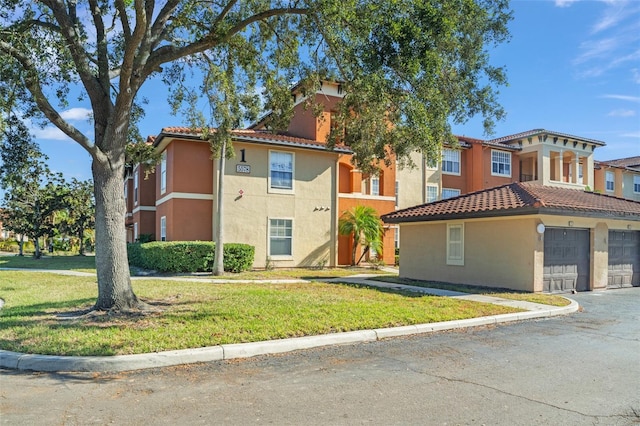 view of front of property featuring a garage and a front lawn