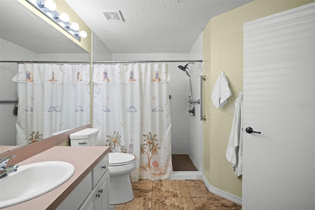 bathroom featuring a shower with shower curtain, tile patterned floors, vanity, a textured ceiling, and toilet