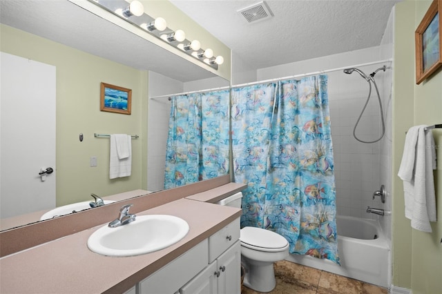 full bathroom with vanity, tile patterned floors, toilet, shower / bath combo with shower curtain, and a textured ceiling