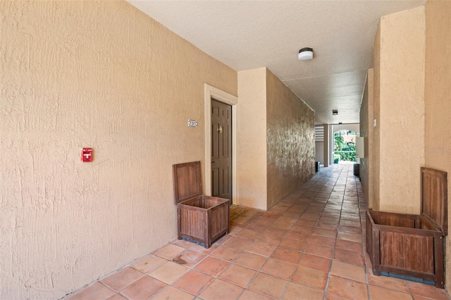 hall featuring light tile patterned floors