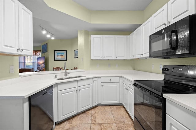 kitchen with white cabinets, sink, kitchen peninsula, and black appliances