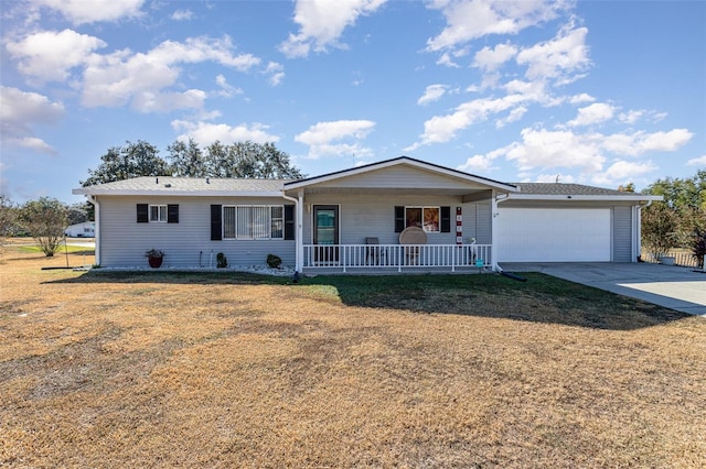 ranch-style home with covered porch, a garage, and a front lawn