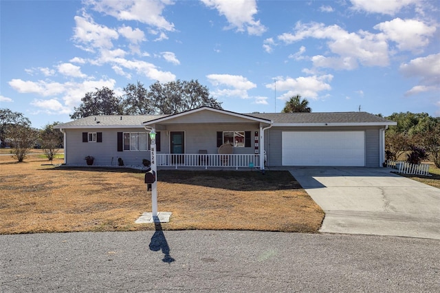 ranch-style house featuring covered porch and a garage