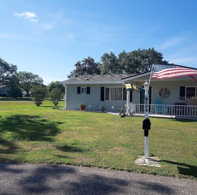 view of front of house with a porch and a front lawn