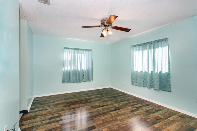 empty room featuring a textured ceiling, dark hardwood / wood-style flooring, and ceiling fan