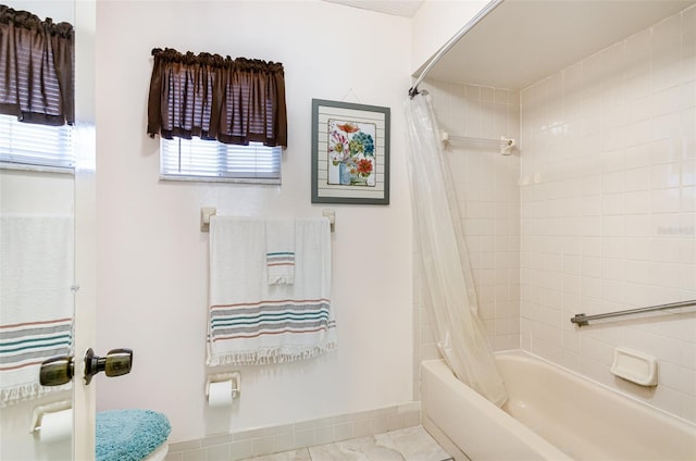 bathroom featuring toilet and shower / bathtub combination with curtain