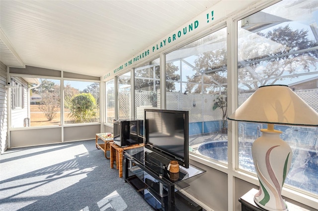 sunroom featuring vaulted ceiling