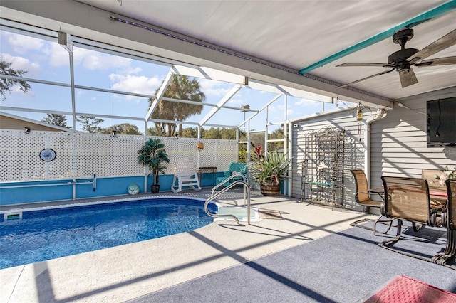 view of swimming pool featuring a lanai, a patio area, and ceiling fan