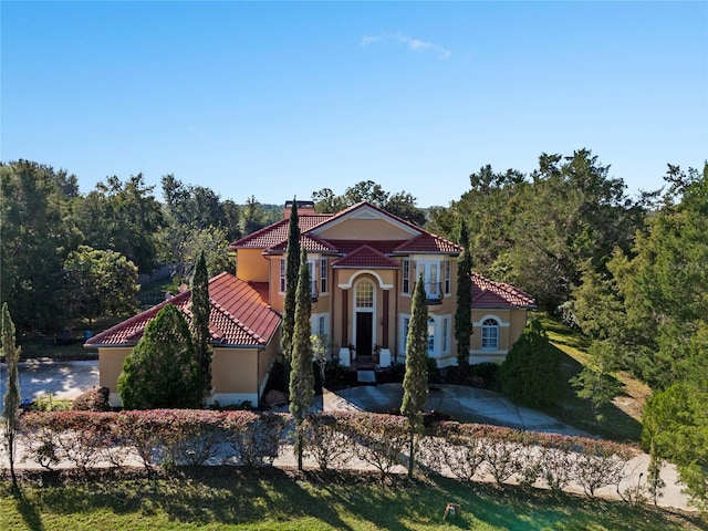 mediterranean / spanish house featuring a front lawn