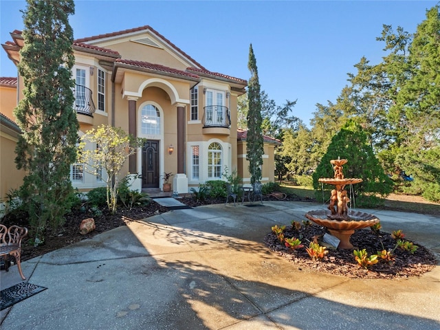 mediterranean / spanish-style house featuring a balcony