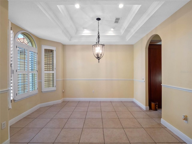 spare room featuring a chandelier, light tile patterned floors, crown molding, and a tray ceiling