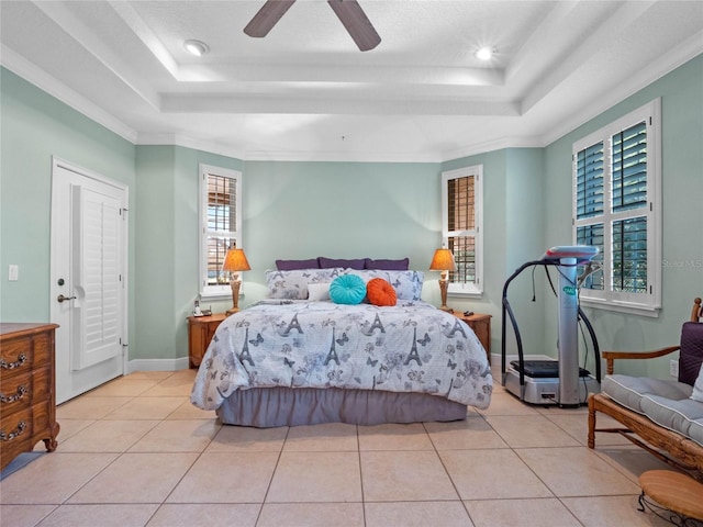 tiled bedroom featuring a tray ceiling, ceiling fan, and crown molding