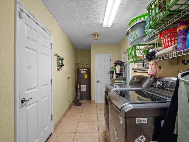 laundry area with separate washer and dryer, water heater, light tile patterned flooring, and a textured ceiling