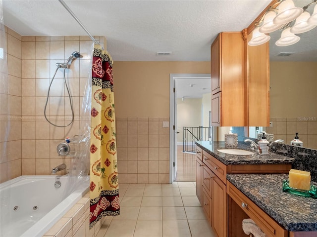 bathroom featuring shower / bath combo, vanity, tile patterned flooring, a textured ceiling, and tile walls