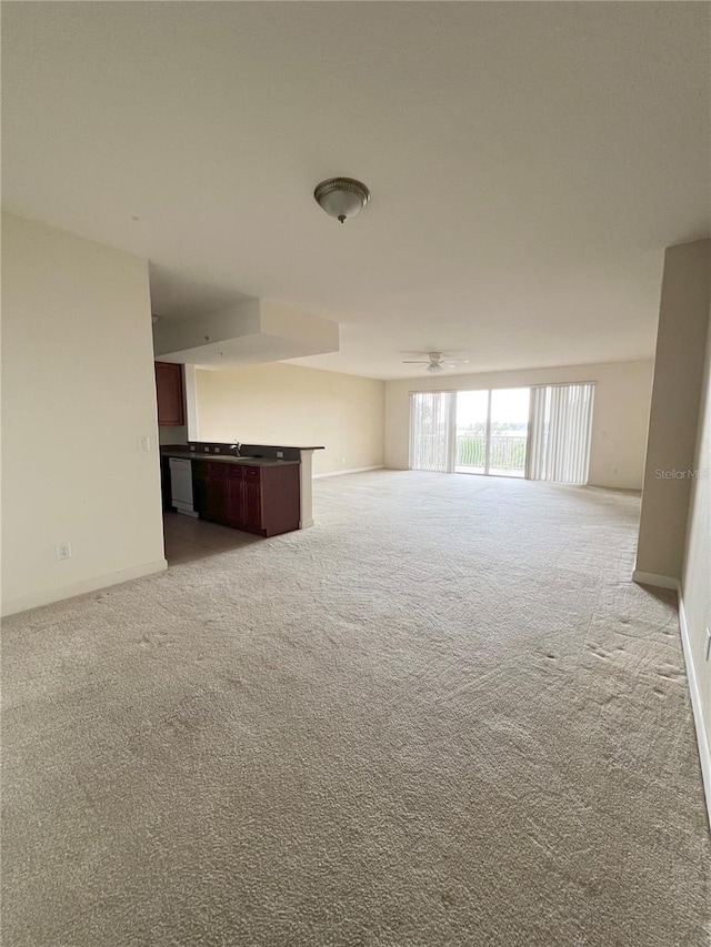 unfurnished living room featuring light carpet