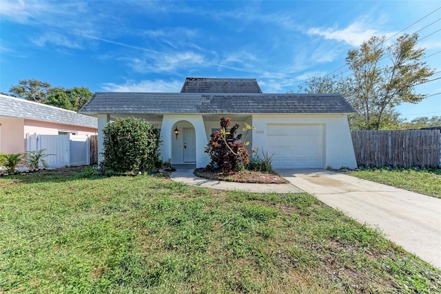 view of front of house featuring a garage and a front lawn