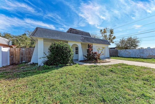 view of front of property with a garage and a front yard