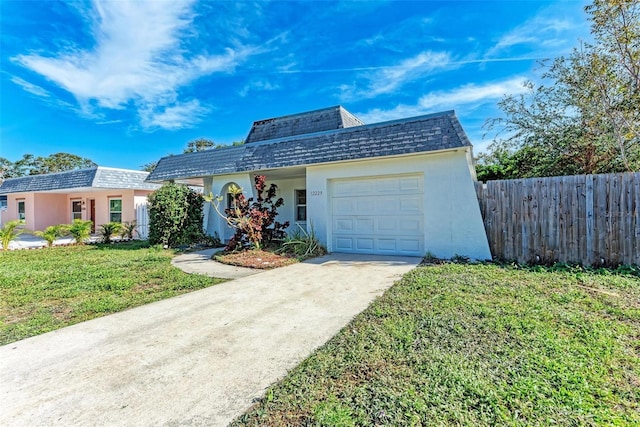 view of front of house featuring a garage and a front lawn