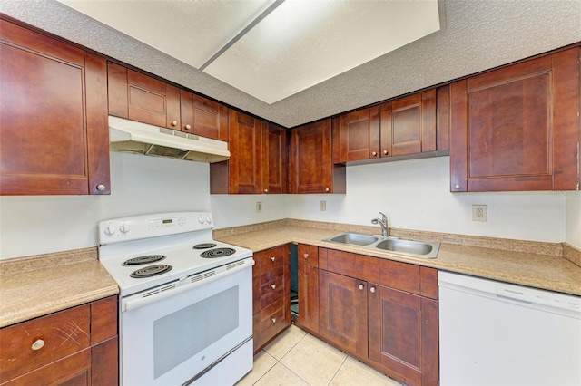 kitchen with light tile patterned floors, white appliances, a textured ceiling, and sink