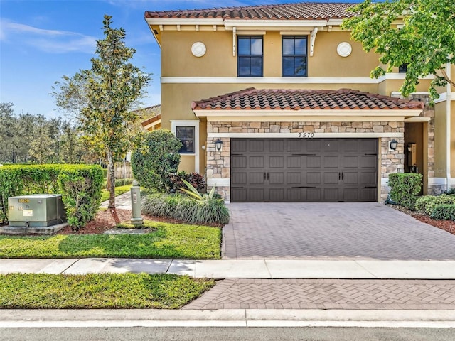 mediterranean / spanish-style home with a garage