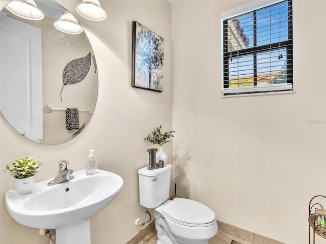 bathroom featuring tile patterned floors, sink, and toilet