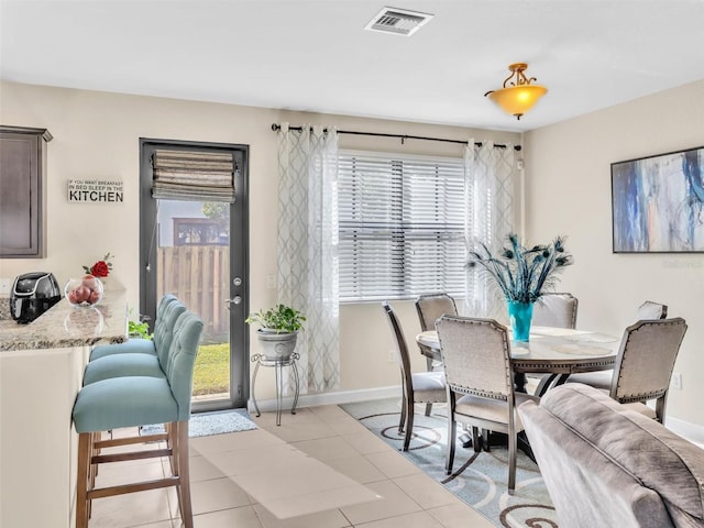 dining space featuring plenty of natural light and light tile patterned floors