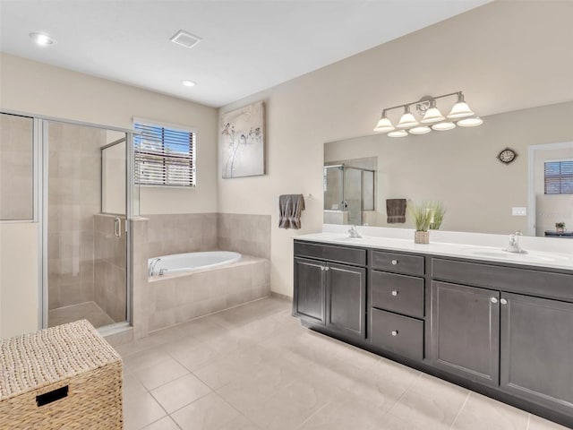 bathroom featuring tile patterned flooring, vanity, and shower with separate bathtub