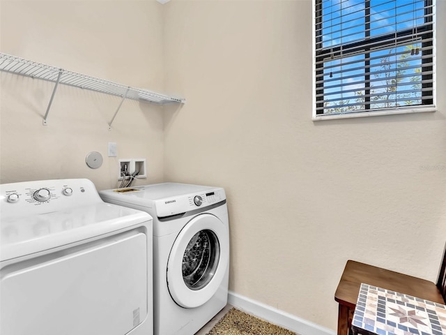 clothes washing area featuring washer and clothes dryer