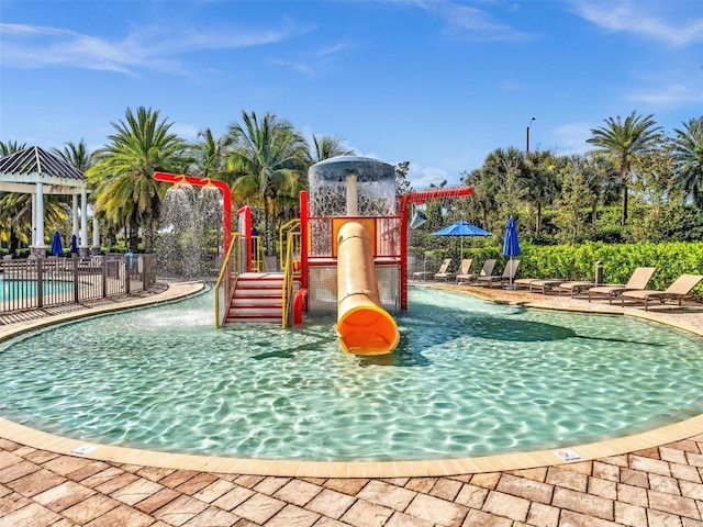 view of playground featuring pool water feature and a community pool