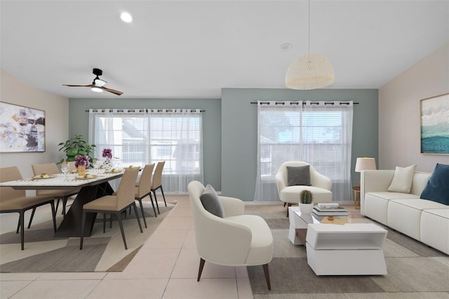 living room with light tile patterned flooring, a wealth of natural light, and ceiling fan